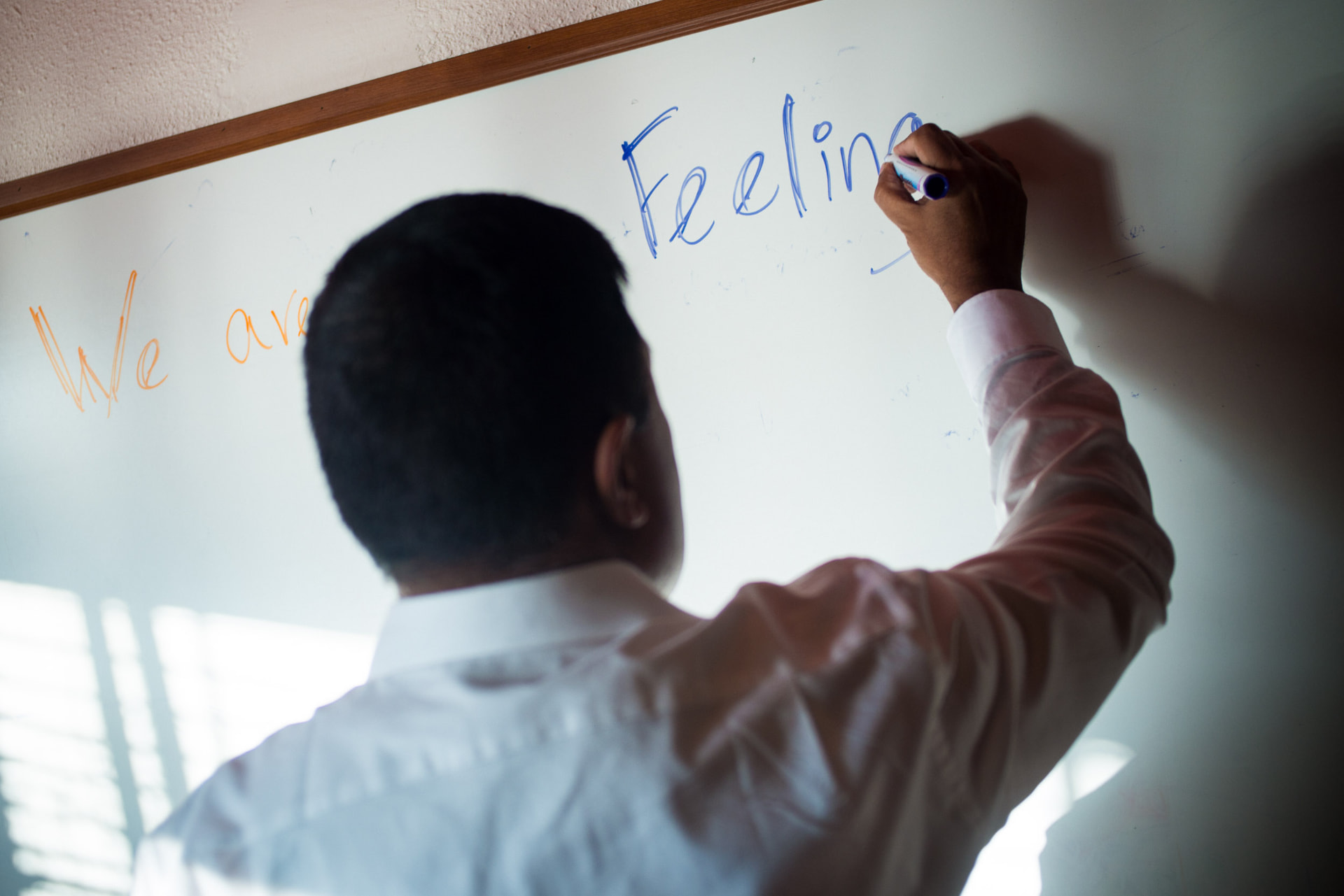 Arjun Sen working through a business idea at a whiteboard
