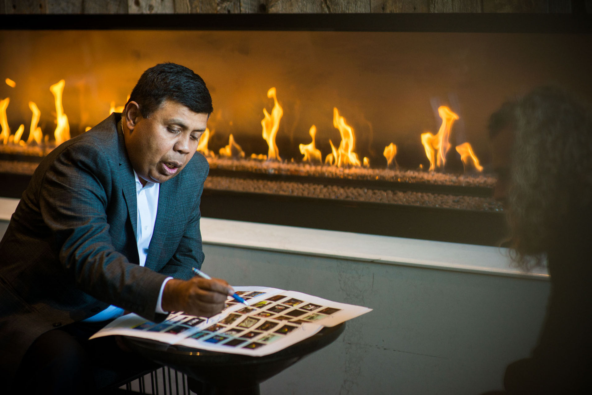 Arjun Sen in conversation with a business leader at a table